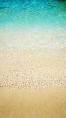 Beautiful sand and soft blue wave of the sea. Summer beach background.