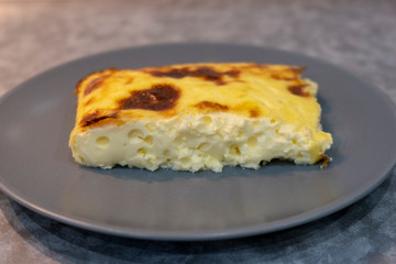 Exquisite egg and cheese casserole on a grey plate