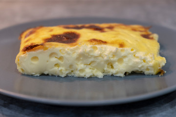 Exquisite egg and cheese casserole on a grey plate