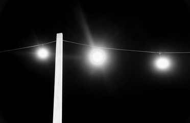 Fototapeta na wymiar Electric lights at night in black and white