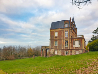 Fototapeta na wymiar Villers-sur-Mer, Normandy, France - Big mansion up on the cliff facing the sea