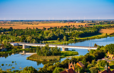 Aerial panoramic view of the Nogat river with a railway bridge by the medieval Teutonic Order Castle in Malbork, Poland