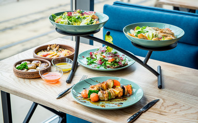 Different dishes on the table in a cafe, restaurant interior