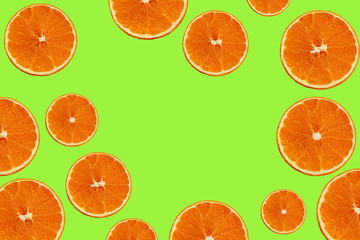 set with juicy slices of orange on a green background for a menu or recipe, the concept of vegetarian, vitamin and healthy food, background, pattern for textile, wallpaper, copy space