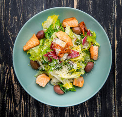 Green and healthy food salmon salad. Against a dark background