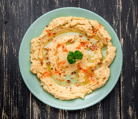 Hummus traditional Jewish creamy lunch salad with chickpeas, olive oil and paprika.