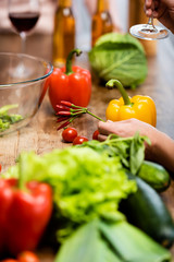 cropped view of woman holding ripe cayenne peppers in kitchen