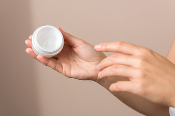 close up view of woman hand moisturising them with cream. skincare