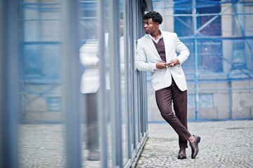 Thoughtful young handsome african american gentleman in formalwear. Black stylish model man in white jacket.