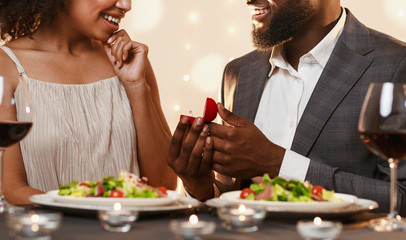Cropped of afro man proposing to his girlfriend