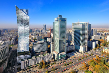 Panoramic aerial view of the skyscrapers - Zlota 44, Intercontinental and Warsaw Financial Center at the Emilii Plater street - in the Srodmiescie downtown district of Warsaw, Poland - obrazy, fototapety, plakaty