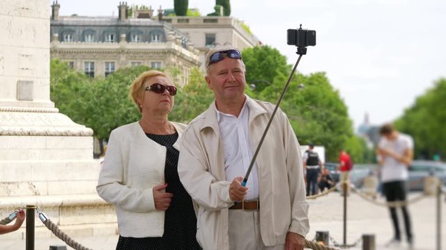 Senior couple taking selfie on Paris street in 4k slow motion 60fps