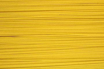Yellow long spaghetti in rows. Food background, texture