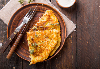 Irish Potato pancakes, latkes or boxty and sauces on wooden background