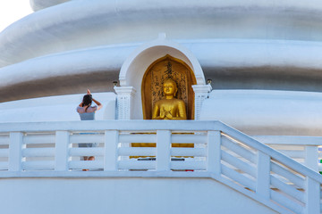 Woman praying at Japanese Peace Pagoda temple in Sri Lanka