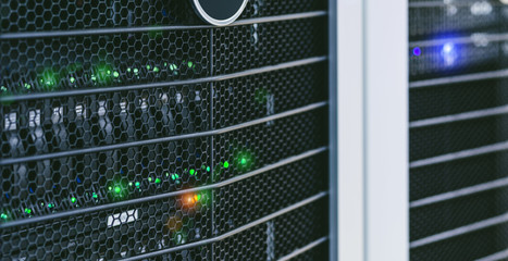 Server units in cloud service data center showing flickering light indicators for massive data...