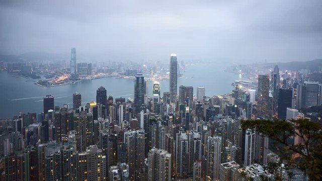 4k time lapse of hazy and misty day to night sunset scene at Hong Kong, aerial view. 