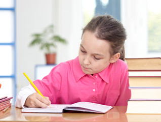 Fototapeta na wymiar little girl writing in classroom education