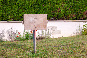 Rectangular stone plate against background of ivy wall. Empty sign board with border, frame. Concept framework, place for text, plate with copyspace