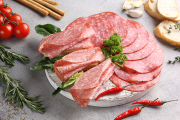 Italian cuisine. Ham and sausage. Sliced meat on a white background. vegetables and bread.Background image. Copy space