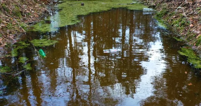 Contaminated water from canalization channels pollutes nature. Environ. Plastic, dead. Water Pollution With Congestion In The Riverbed. Urban Garbage Global Problem. Environmental.