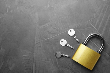 Steel padlock, keys and space for text on grey background, flat lay. Safety concept