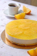 Homemade delicious sweet passion fruit orange cake, mousse dessert on cup of coffee americano, white background. Organic dessert sugarless. Healthy eating.