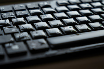  drops of water on a black keyboard