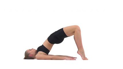 Beautiful young woman performing stretching exercise, standing in bridge pose. Isolated, on white background