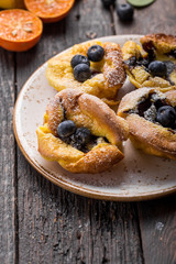 Pannukakku  or Danish pancake with berries topping covered with sugar powder
