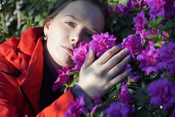 woman posing with azalea flowers in garden