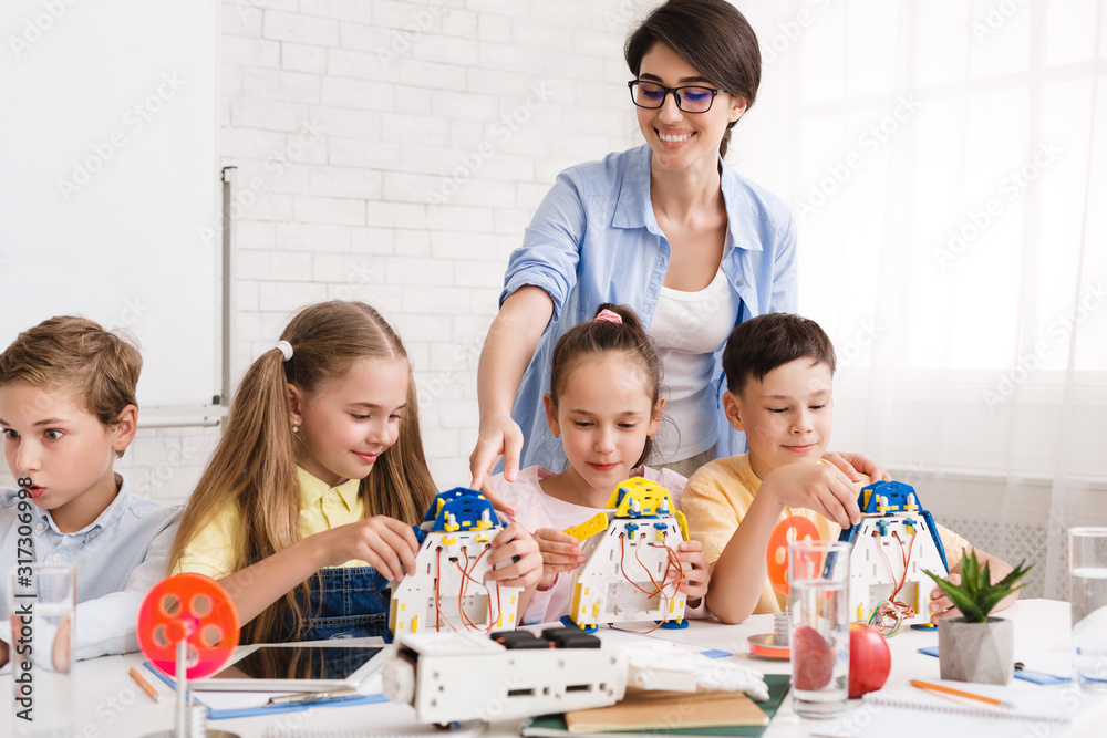 Poster Pupils constructing modern robots with teacher's help