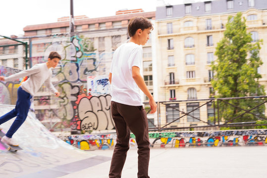 Teenage boys skateboarding at skateboard park