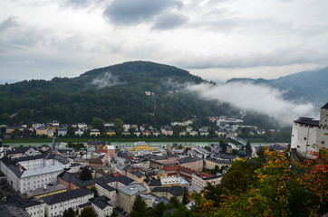 Fototapeta na wymiar Top view of the Salzach river and the old city in center of Salzburg, Austria, from the walls of the fortress in cloudy autumn day 