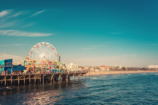 Santa Monica, CA, USA - Aug 2, 2018: Santa Monica iconic ferris wheel in amusement park in sunset light, view from pier