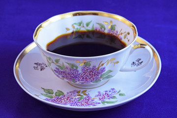 Fresh, fragrant coffee in a beautiful Cup on a blue background.