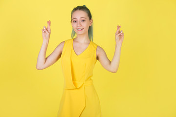 beautiful young woman in a yellow dress on a yellow background