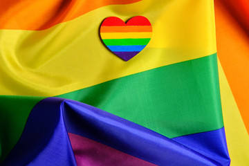 Close-up view of the LGBT pride flag with the heart coloured in LGBTQ pride colours. Concept of the Valentine day, freedom, equality