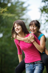 teenage girls having fun piggyback