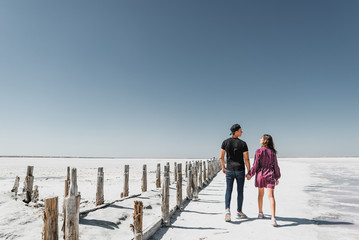 love story in the desert, happy young couple,young people are walking and holding hands,love story in a beautiful place,summer vacation for a young couple,beautifully dressed young people in love,runn