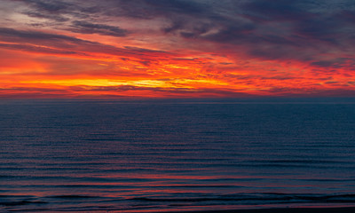 Fototapeta na wymiar sea sunset landscape with colorful skies and dark water