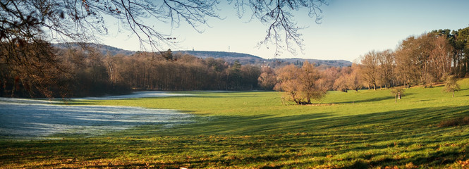 First snow on green field in germany outdoor.