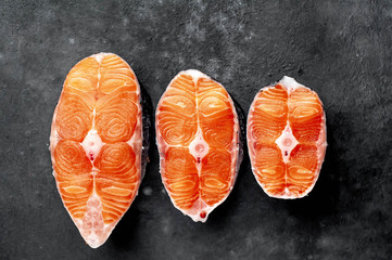 fresh raw salmon steaks on a stone 