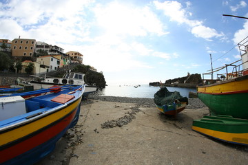 some fishing boats in the harbor in camera de lobos at Madeira island