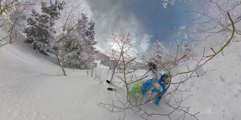 Fototapeta SELFIE: Young man tree skiing in Park City falls into the deep powder snow. obraz