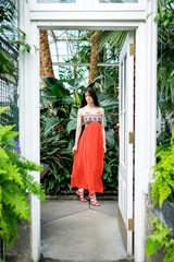 Beautiful woman during Spring time in a greenhouse