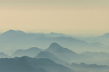 Scenic mountains range background in morning haze