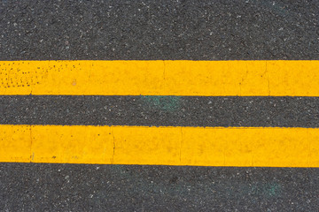 Double yellow lines on city street.