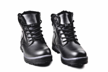 Winter men’s black leather boots on a white background, hiking shoes, practical off-road shoes, close-up