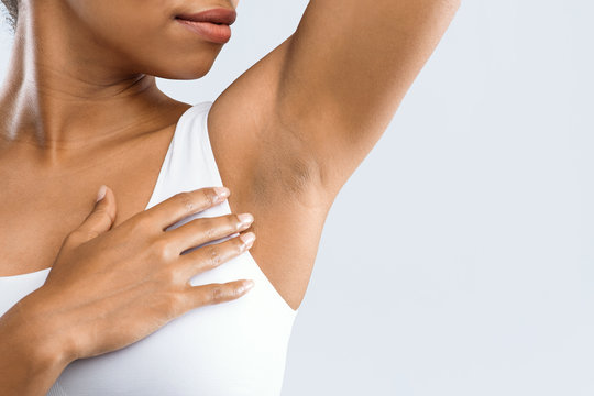 Cropped Of Black Girl Smelling Her Armpit